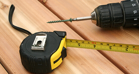 Photo of a tape measure and drill